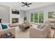 Bright living room with large windows, a fireplace, hardwood floors, and comfortable seating at 2821 Providence Spring Ln, Charlotte, NC 28270
