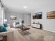 Living room with neutral walls and light wood-look floors, tastefully decorated at 2821 Providence Spring Ln, Charlotte, NC 28270