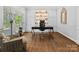 Spacious office with custom built-ins, hardwood floors, and comfortable seating at 2821 Providence Spring Ln, Charlotte, NC 28270