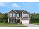 Charming two-story home with a stone-accented garage and a beautifully landscaped front yard at 308 Balboa St, Matthews, NC 28104