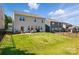 Fenced backyard with a well-maintained lawn, patio seating, and plenty of space for outdoor entertaining at 3471 Melwood Estates Dr, Denver, NC 28037