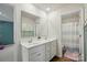 Bright bathroom with double sinks, white cabinetry, and a walk-in shower for a spa-like experience at 3471 Melwood Estates Dr, Denver, NC 28037