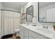 Modern bathroom with double sinks, black framed mirrors, and a shower featuring a stylish curtain at 3471 Melwood Estates Dr, Denver, NC 28037