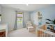 Well-lit Bedroom with a white rocking chair, crib, and blue accents, creating a serene environment at 3471 Melwood Estates Dr, Denver, NC 28037