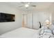 Bright and airy bedroom featuring a ceiling fan, closet space, and a well-lit desk area at 3471 Melwood Estates Dr, Denver, NC 28037