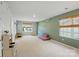 Spacious bonus room with neutral carpet, play area, and ample natural light for creative activities at 3471 Melwood Estates Dr, Denver, NC 28037