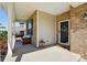 Covered front porch with seating area and brick columns, offering a welcoming entrance at 3471 Melwood Estates Dr, Denver, NC 28037