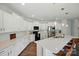 This modern kitchen features white cabinets, stainless steel appliances, and a spacious island with seating at 3471 Melwood Estates Dr, Denver, NC 28037
