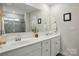 Bright bathroom with double vanity, large mirror, and sleek fixtures at 3471 Melwood Estates Dr, Denver, NC 28037