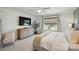Airy bedroom featuring a plush king bed, dresser and a large window with natural light at 3471 Melwood Estates Dr, Denver, NC 28037