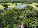 Aerial view of a golf course community featuring lush greenery, serene lakes, and picturesque homes nestled among mature trees at 3531 Bon Rea Dr, Charlotte, NC 28226