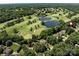 Expansive aerial view of a lush golf course community with serene lakes and beautiful homes nestled among mature trees at 3531 Bon Rea Dr, Charlotte, NC 28226