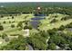 Scenic aerial view of golf course with ponds, greens and lush tree canopy in residential area at 3531 Bon Rea Dr, Charlotte, NC 28226