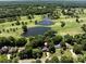 Aerial view of the home with a golf course and pond nearby, situated among mature trees in a residential neighborhood at 3531 Bon Rea Dr, Charlotte, NC 28226