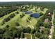 Expansive aerial view of a lush golf course community with serene lakes and beautiful homes nestled among mature trees at 3531 Bon Rea Dr, Charlotte, NC 28226