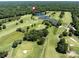 Overhead view of a golf course with ponds and greens, surrounded by residential homes nestled among mature trees at 3531 Bon Rea Dr, Charlotte, NC 28226