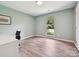 Bedroom with hardwood flooring, large window, neutral colored walls and a desk at 3531 Bon Rea Dr, Charlotte, NC 28226