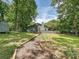 Charming gray home featuring a beautiful deck and picturesque landscaping surrounded by mature trees and inviting walkway at 3531 Bon Rea Dr, Charlotte, NC 28226