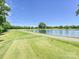 Scenic view of a golf course featuring a serene pond and lush green landscape at 3531 Bon Rea Dr, Charlotte, NC 28226