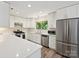 Modern kitchen featuring white cabinets, stainless steel appliances, and lots of countertop space at 3531 Bon Rea Dr, Charlotte, NC 28226