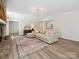 Comfortable living room features a decorative rug and fireplace with stone surround at 3531 Bon Rea Dr, Charlotte, NC 28226