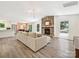 Bright living room boasts a stone fireplace, wood floors, and seamless flow to dining area at 3531 Bon Rea Dr, Charlotte, NC 28226