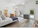 Bright main bedroom featuring vaulted ceilings, plank flooring, and multiple windows at 3531 Bon Rea Dr, Charlotte, NC 28226