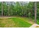Grassy backyard space with surrounding tall trees and wooded backdrop at 501 Old Speedway Nw Dr # 1, Concord, NC 28027