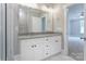 Bathroom with double sinks, granite countertops, and large mirror at 501 Old Speedway Nw Dr # 1, Concord, NC 28027