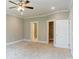Large bedroom featuring carpet, neutral paint, crown molding, closet, and attached bathroom at 501 Old Speedway Nw Dr # 1, Concord, NC 28027