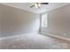 Bedroom featuring carpet, neutral paint, and two windows at 501 Old Speedway Nw Dr # 1, Concord, NC 28027