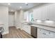 Well-lit kitchen featuring white cabinets, stainless steel appliances, and granite countertops at 501 Old Speedway Nw Dr # 1, Concord, NC 28027