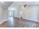 Spacious living room with wood-look floors, a vaulted ceiling, and neutral paint at 501 Old Speedway Nw Dr # 1, Concord, NC 28027