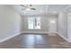 Cozy living room with hardwood flooring, vaulted ceilings, and natural light from the windows at 501 Old Speedway Nw Dr # 1, Concord, NC 28027