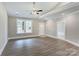 Bright living room with hardwood floors, a ceiling fan, and access to the front entrance at 501 Old Speedway Nw Dr # 1, Concord, NC 28027