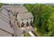 Wide aerial view of townhomes with private garages and balconies, nestled in a lush, green community at 513 Cubitt Ct, Charlotte, NC 28205