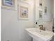 Modern powder room with stylish sink, brushed metal faucet, and coastal artwork at 513 Cubitt Ct, Charlotte, NC 28205