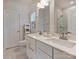 Bright bathroom featuring a double vanity, framed mirrors, and a toilet, with linen storage nearby at 513 Cubitt Ct, Charlotte, NC 28205