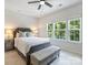 Well-lit bedroom with a cushioned bench seat, plush bedding, and bedside lamps on either side of the bed at 513 Cubitt Ct, Charlotte, NC 28205