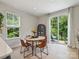 Dining area with a rustic table, wood chairs, and access to outdoor deck at 513 Cubitt Ct, Charlotte, NC 28205
