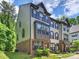 Three-story townhome with brick accents, neutral siding, and dark shutters at 513 Cubitt Ct, Charlotte, NC 28205