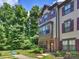 Three-story townhome with brick accents, neutral siding, and dark shutters at 513 Cubitt Ct, Charlotte, NC 28205