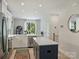 Bright kitchen with stainless steel appliances, island with quartz countertop, and a modern design at 513 Cubitt Ct, Charlotte, NC 28205