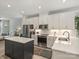 Modern kitchen with stainless steel appliances, white cabinets, and open to living area at 513 Cubitt Ct, Charlotte, NC 28205