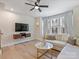 Bright living room with hardwood floors, modern furniture, and a mounted TV at 513 Cubitt Ct, Charlotte, NC 28205