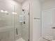 Modern shower with sleek glass enclosure and contemporary tile, next to a white bathroom door at 513 Cubitt Ct, Charlotte, NC 28205