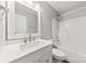 A modern bathroom featuring bright lighting, marble countertop, white cabinets, and white fixtures at 522 Klondike Ln, Charlotte, NC 28216