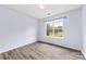 This cozy bedroom features beautiful wood floors and a window with natural light at 522 Klondike Ln, Charlotte, NC 28216