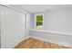 Bedroom featuring light blue walls, a window seat, wood floors, and a sliding closet at 5414 Leaford Ct, Charlotte, NC 28227