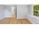 Bedroom featuring light blue walls, wood floors, a window seat, and a closet at 5414 Leaford Ct, Charlotte, NC 28227